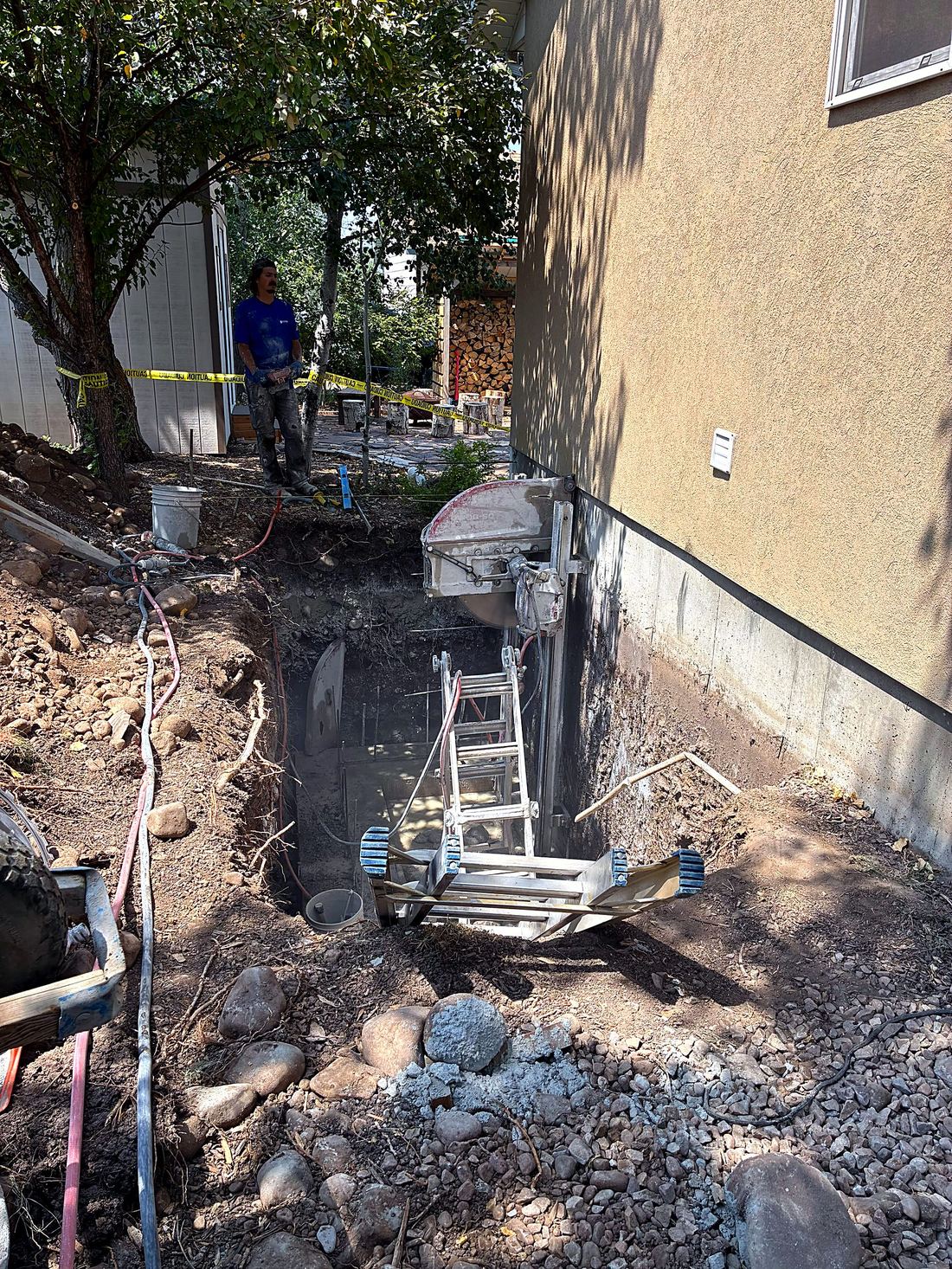 Wall saw making a precision egress window cut in a concrete foundation