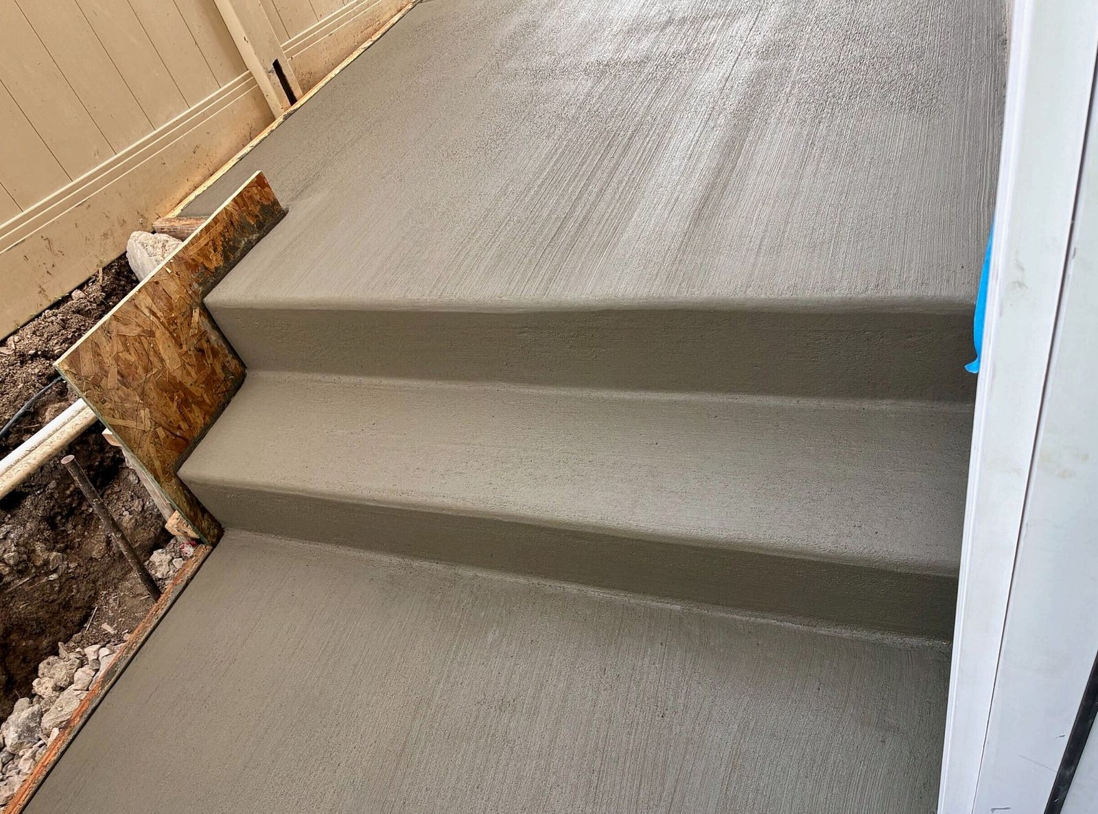 Finished concrete entry steps and landing at a Utah basement walkout