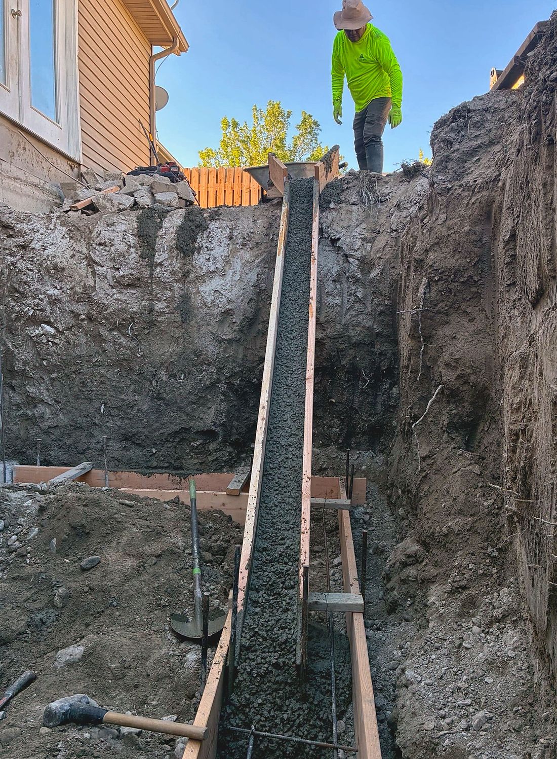 Fresh concrete placed through a chute for stairwell footings