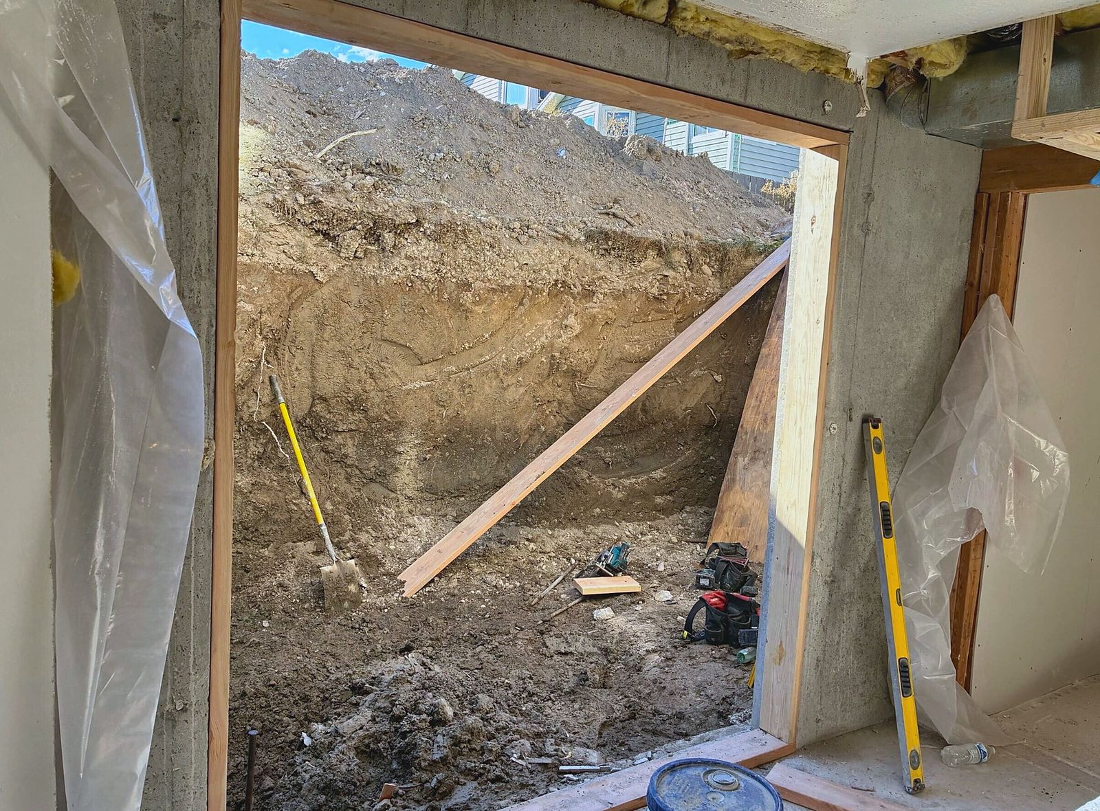 New framed exterior opening cut through the foundation, seen from inside