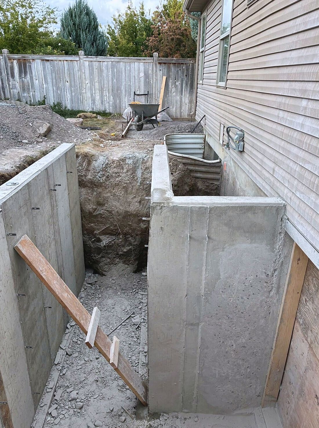 Newly poured concrete retaining walls forming the stairwell