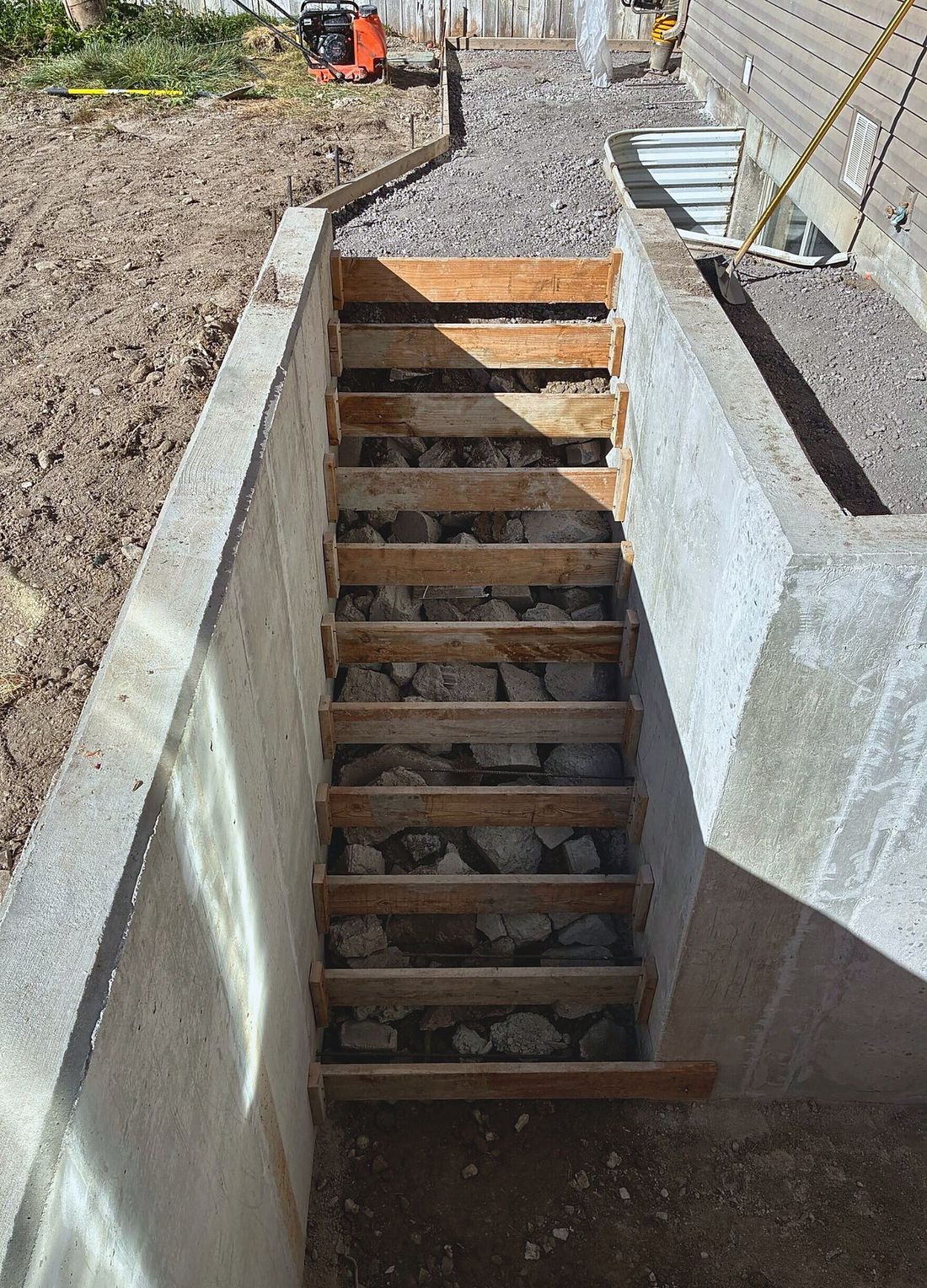 Wood stair forms set between poured concrete walls